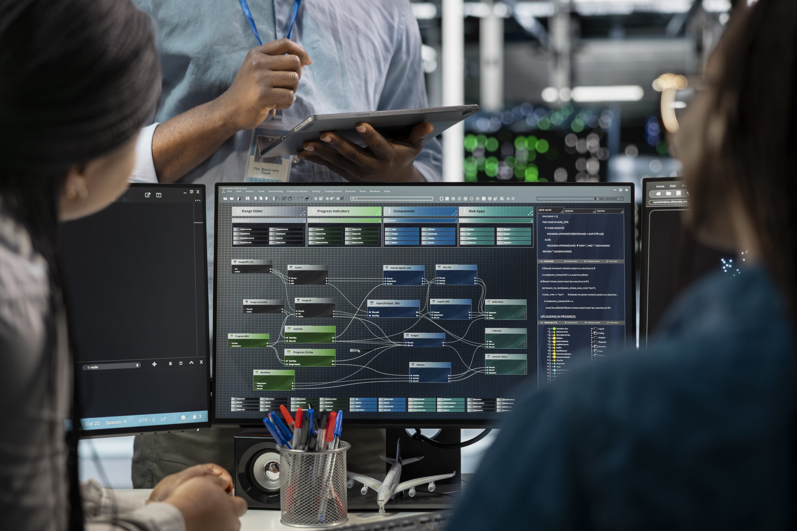 Close up of data center programmers using PC to visualize artificial intelligence neural networks. Server farm IT experts looking at monitor, working together to oversee AI systems